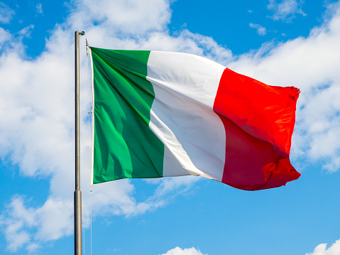 National Flag Of Italy Waving Into Blue Sky